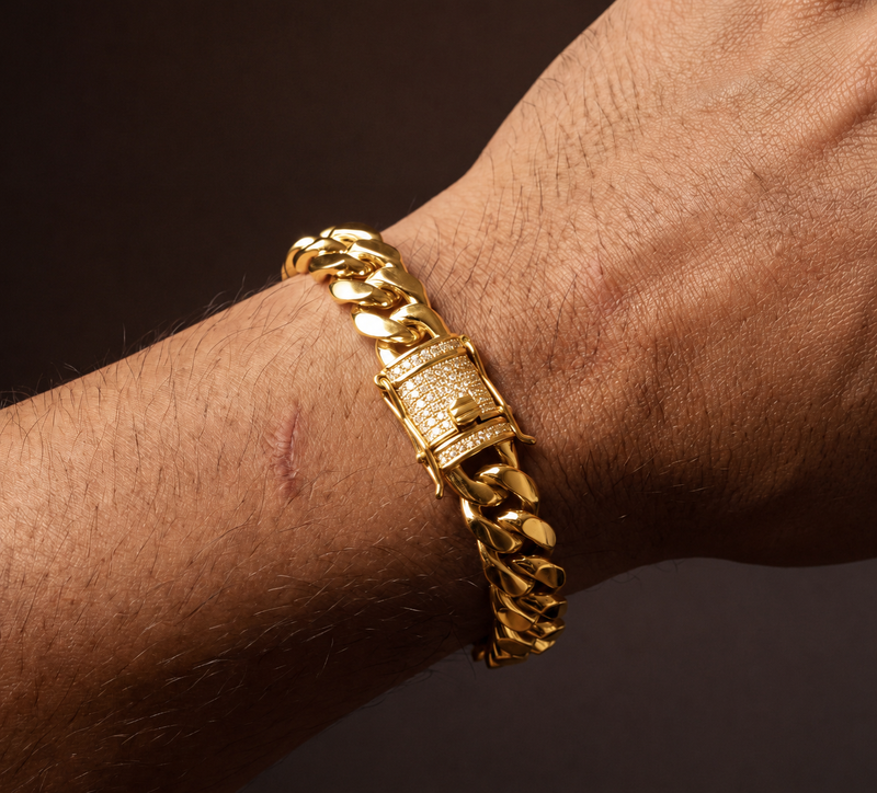 Gold-tone Miami Cuban link bracelet with a pave cubic zirconia box lock, worn on a wrist