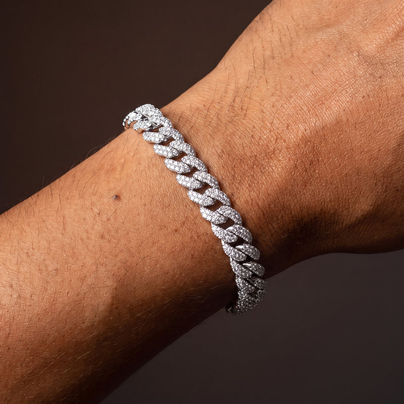 Silver-tone iced out Miami Cuban link bracelet worn on a wrist, 10 mm micro-pave links