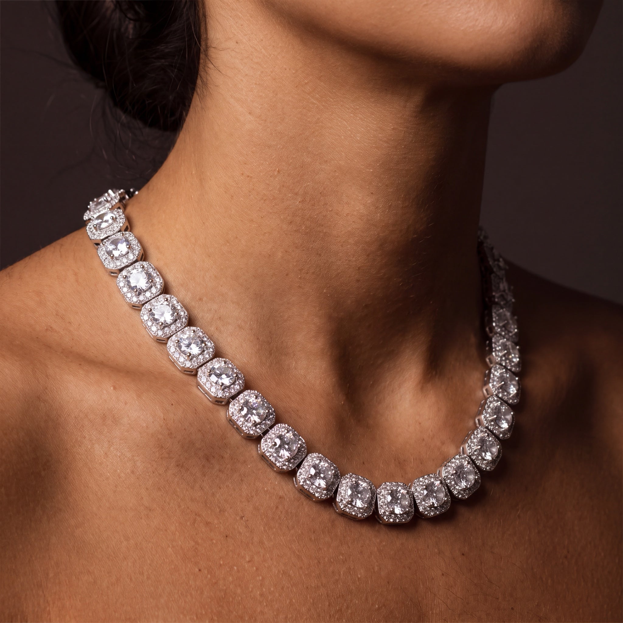 Clustered tennis chain worn, angled view at the collar