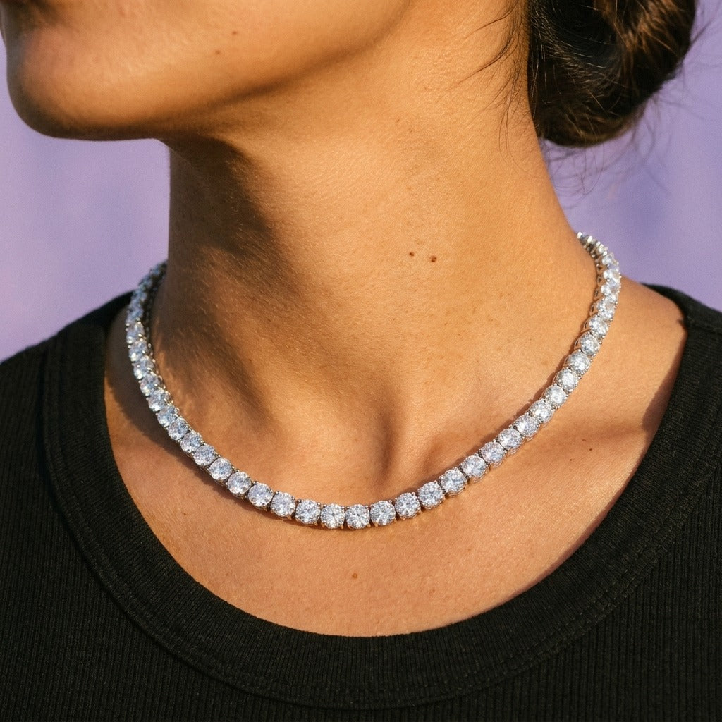 Cubic zirconia tennis necklace worn on a woman's neck over a black top
