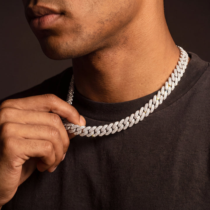 Iced Miami Cuban chain worn with a hand adjusting the links